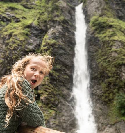 Kind freut sich über Wasserfall bei der Liechtensteinklamm