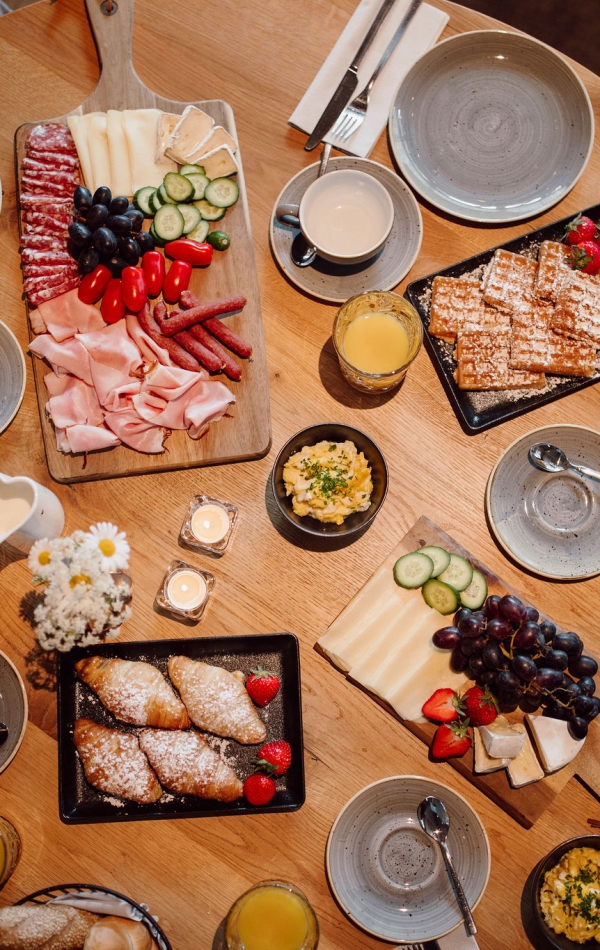 Draufsicht eines runden gedeckten Frühstückstisches im Restaurant Glückskind Ferienresort Central Flachau